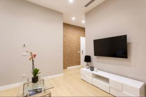a living room with a flat screen tv on a wall at Casa Ilaria in Naples