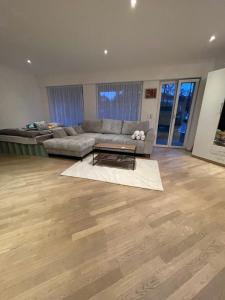 a living room with a couch and a table at Your exclusive 2 room & 2 bathroom natural holiday home in Winterthur +28 photos