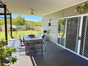 a screened in porch with a table and chairs at Boyanup West Wing in Boyanup