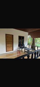 a room with chairs and a table and a building at RED PEARL BEACH RESORT in Chaloklum