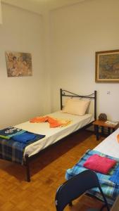 a bedroom with a bed and a chair in it at HELLAS PALACE ROOMS balcony in Sparta +170 photos