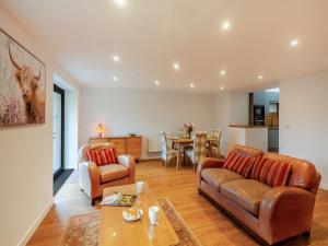 a living room with a couch and a table at The Aran - Uk51067 in Frongoch