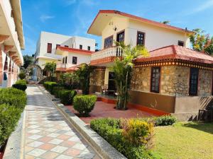 a house with a pathway in front of it at Sajjan Bagh Resort in Pushkar