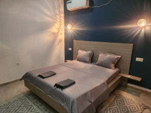 a bedroom with a bed with two towels on it at Jasmin Prestige Duplex - Hammamet in Hammamet