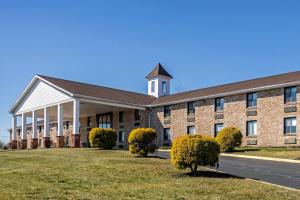 a large brick building with a clock tower on top at Quality Inn Enola - Harrisburg in Harrisburg