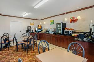 a restaurant with tables and chairs and a counter at Quality Inn Enola - Harrisburg in Harrisburg
