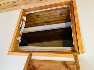 a window in a wooden box in a room at Anaélodge in Le Tampon