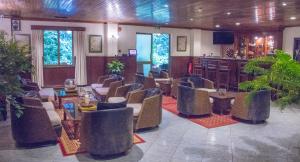 a restaurant with chairs and tables and a bar at La Mada Hotel in Nairobi