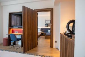 a room with a door leading into a room with a bedroom at Hampton By Hilton Sakarya in Sakarya +46 photos