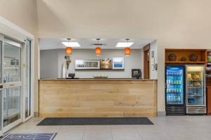 a bar in a restaurant with a counter and a refrigerator at Country Inn & Suites by Radisson, Des Moines West, IA in Clive