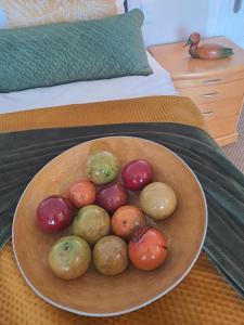 a bowl of different types of vegetables on a bed at Boutique Inn - Quintessence in Gordonʼs Bay +2 photos