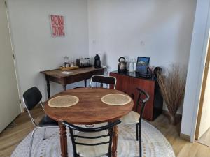 a wooden table and chairs in a room at Zen suite Moulin de Vilaine in Châteauroux