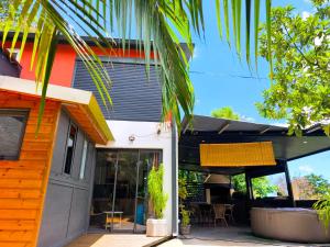 a house with a porch with a patio at Ti Kaz Luxuriante - Jacuzzi Privé - Évasion Tropicale & Intimité in Saint-Louis