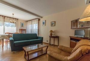 a living room with a couch and a table at Le mas clair in Pins-Justaret