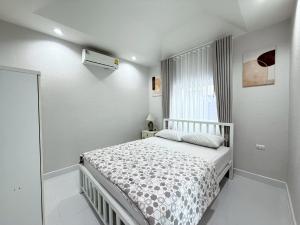 a small bedroom with a bed and a window at Buddy pool villa in Nong Prue +21 photos