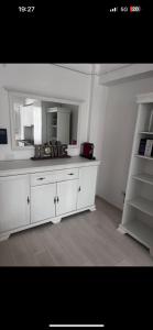 a kitchen with a white counter and a mirror at Expo Copou in Iaşi