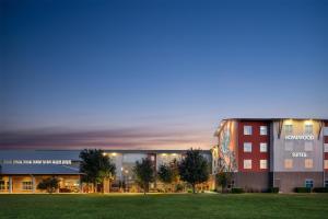 a rendering of the campus at night at Homewood Suites TechRidge Parmer @ I-35 in Austin
