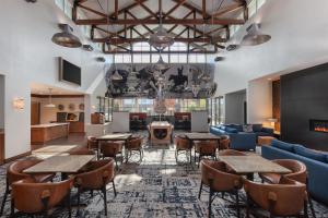 a lobby of a hotel with tables and chairs at Homewood Suites TechRidge Parmer @ I-35 in Austin