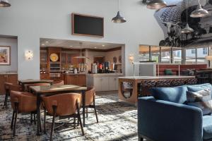 a restaurant with tables and chairs and a bar at Homewood Suites TechRidge Parmer @ I-35 in Austin