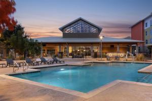 a large swimming pool in front of a building at Homewood Suites TechRidge Parmer @ I-35 in Austin