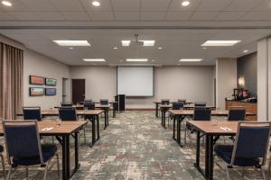 a conference room with tables and chairs and a whiteboard at Homewood Suites TechRidge Parmer @ I-35 in Austin +48 photos