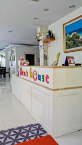 a restaurant counter with a sign that reads donuts at Ben's House in Ao Nang Beach