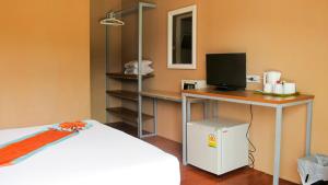 a room with a desk with a computer on it at Uphill Cottage in Phi Phi Islands