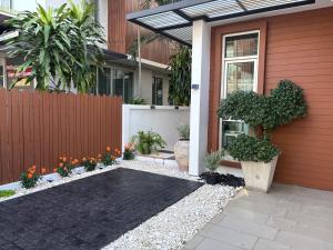 a house with a fence and a black driveway at Vanilla Villa in Ban Yep Chaeng