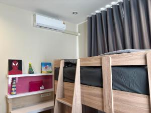 a bedroom with a wooden bunk bed with a window at Vanilla Villa in Ban Yep Chaeng