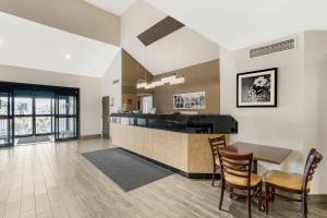 a kitchen with a table and chairs in a room at Sleep Inn Billings in Billings