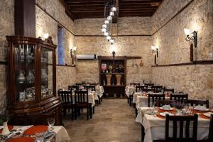 a restaurant with tables and chairs in a room at Osmanli Marco Pasha Hotel in Tarsus