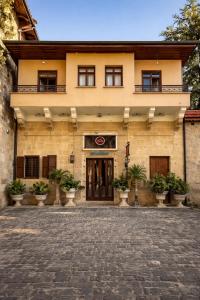 a building with a courtyard in front of it at Osmanli Marco Pasha Hotel in Tarsus