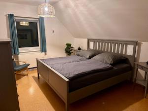 a bedroom with a bed in a room with a window at Ferienhaus Isaro in Ludwigsburg