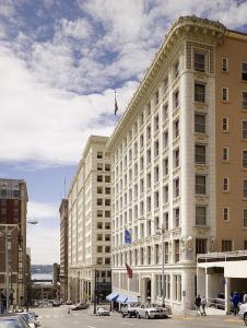 a large white building with a flag on top of it at Arctic Club Hotel in Seattle