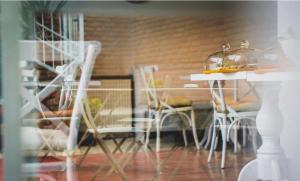 a dining room with white chairs and a table at Boutique Hotel Meidan View in Tbilisi City