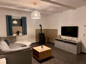 a living room with a couch and a flat screen tv at Ferienhaus Isaro in Ludwigsburg