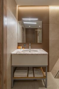 a bathroom with a sink and a mirror at Apart Hotel Istaravshan in Tashkent +35 photos