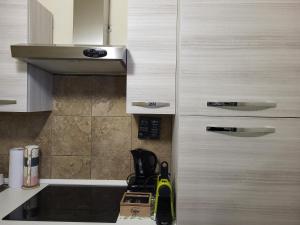 a kitchen with white cabinets and a yellow appliance at Dolce Dormire in Vigevano +23 photos