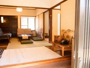 a room with a bed and a living room at Vegestay Nonaka in Tanabe