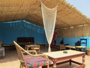 a room with chairs and a table and a net at Arabian Nights Hostel in Cairo