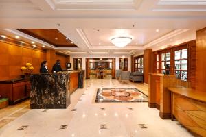 a lobby of a hotel with a reception desk at Hotel Parle International in Mumbai