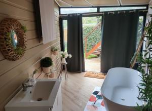 a bathroom with a sink and a mirror and a window at Le Lys des Makes in Saint-Louis +40 photos