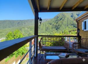 a balcony with chairs and a view of a mountain at Le Lys des Makes in Saint-Louis