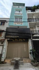 a building with a garage door in front of it at Hội Home in Ho Chi Minh City