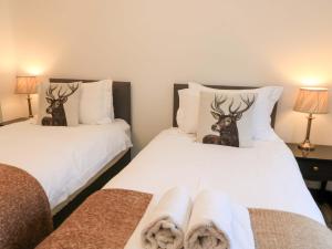 two beds with deer heads on them in a room at The Annex in Wimborne Minster