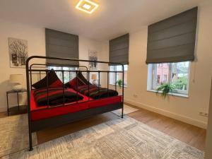 a bedroom with a bed with red pillows at Ferienpark Worpswede in Worpswede