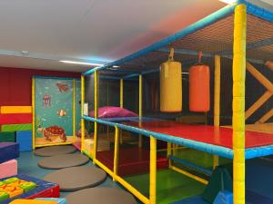 a childrens play room with a bunk bed with boxing equipment at Hotel Apostroff in Koksijde