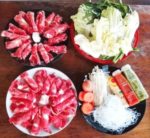 four bowls filled with vegetables on a wooden table at Western View Chiangdao Camping in Chiang Dao