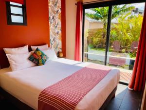 a bed in a room with a large window at Anaélodge in Le Tampon +43 photos