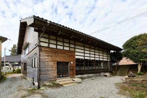 a wooden building with a door on the side of it at kitanUOZU in Uozu